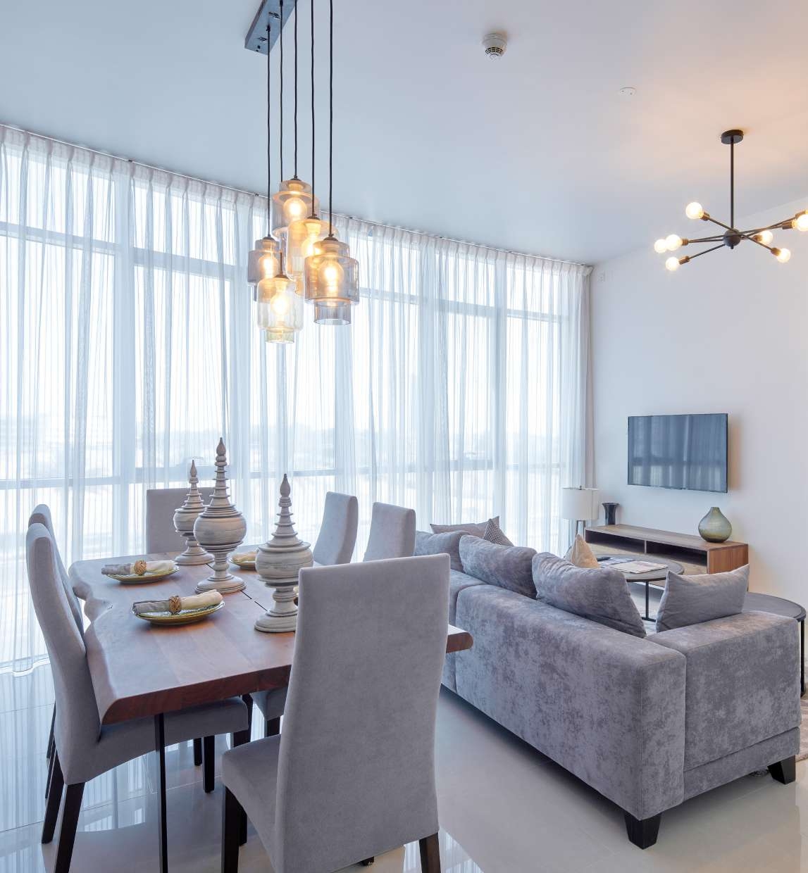 Bright open-plan living and dining space at Julphar Residence on Al Reem Island.