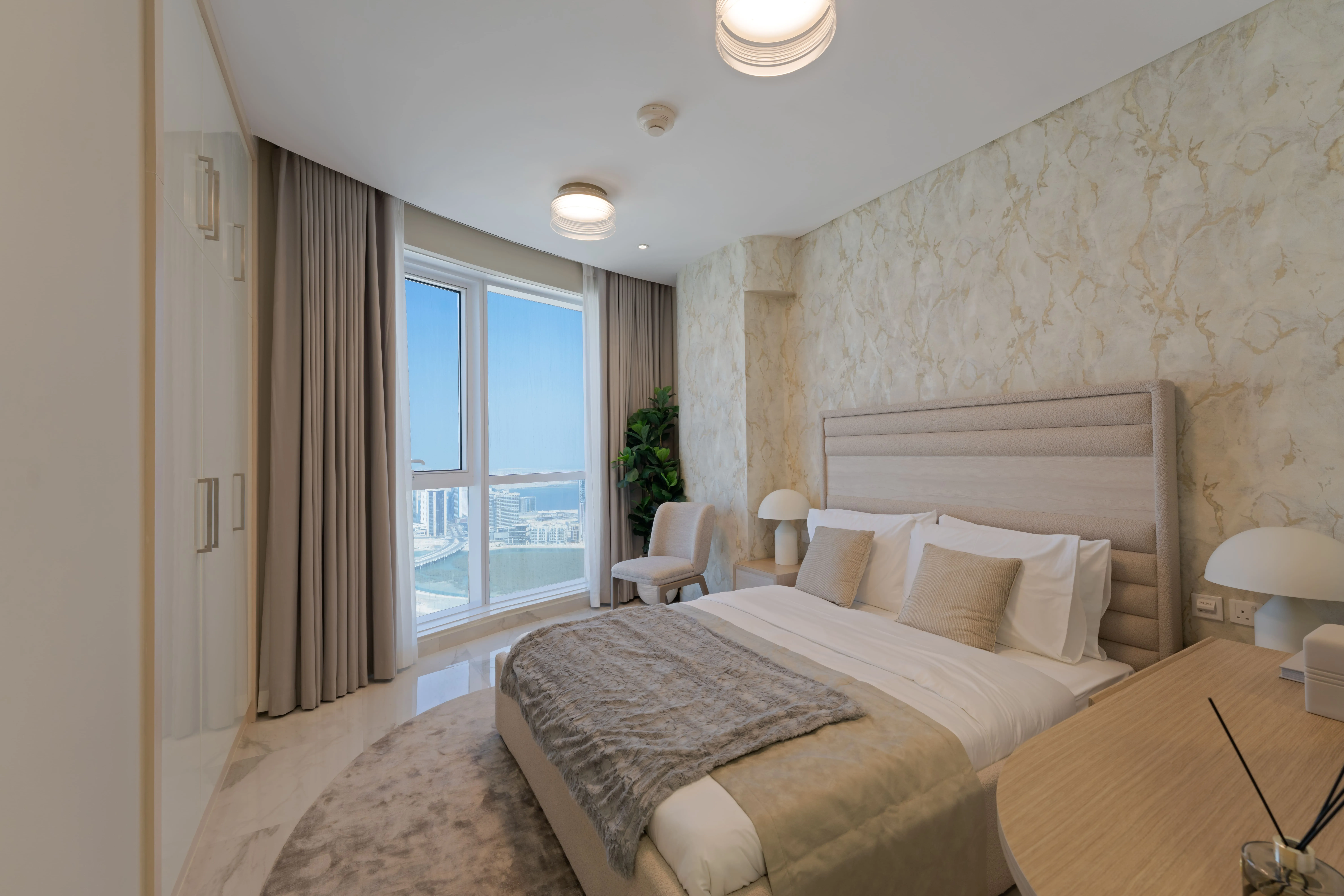 Spacious guest bedroom at Leaf Tower with comfortable contemporary design.
