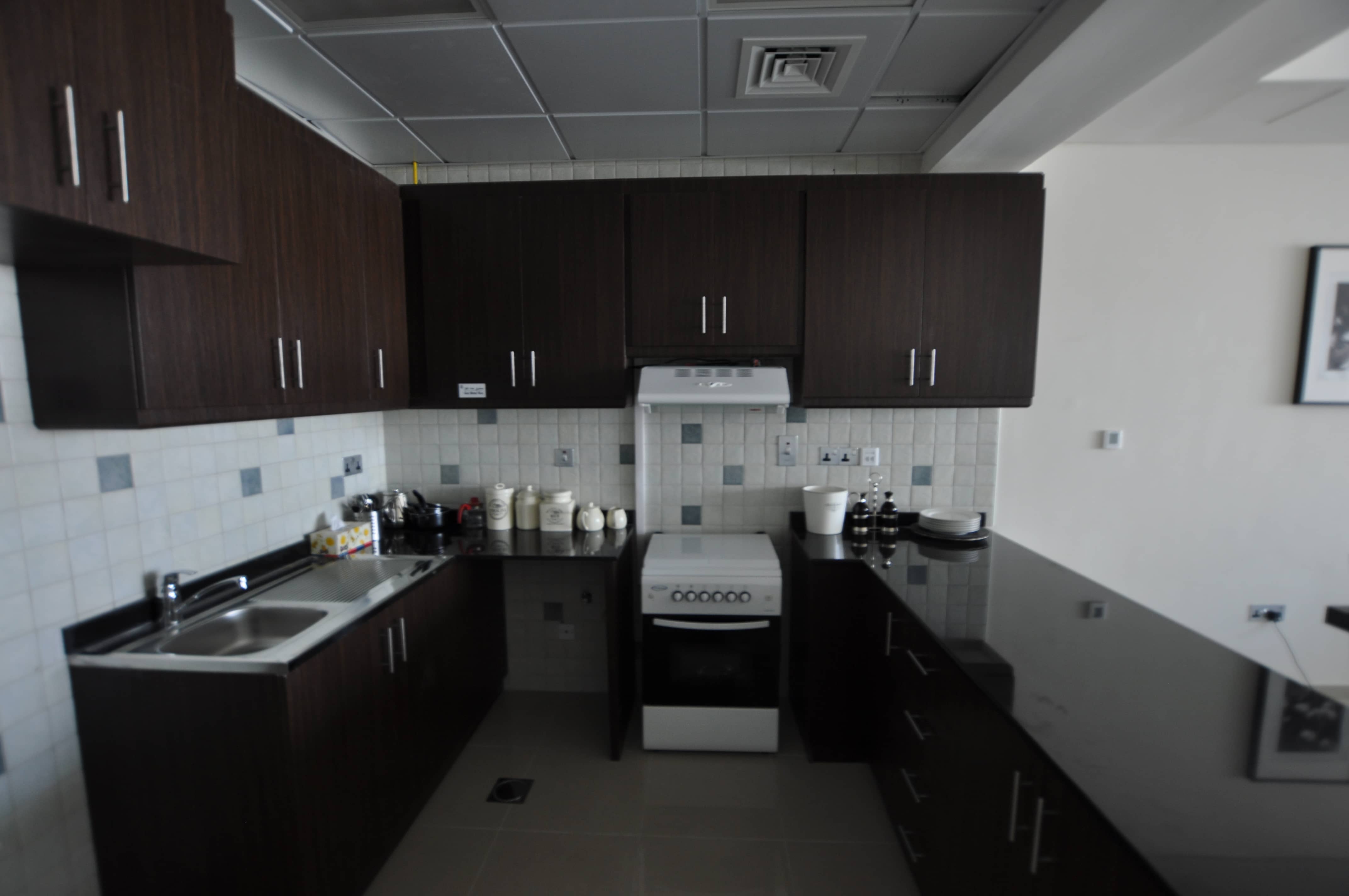 Contemporary kitchen at Hydra Avenue Abu Dhabi apartment featuring quality finishes and functional modern design