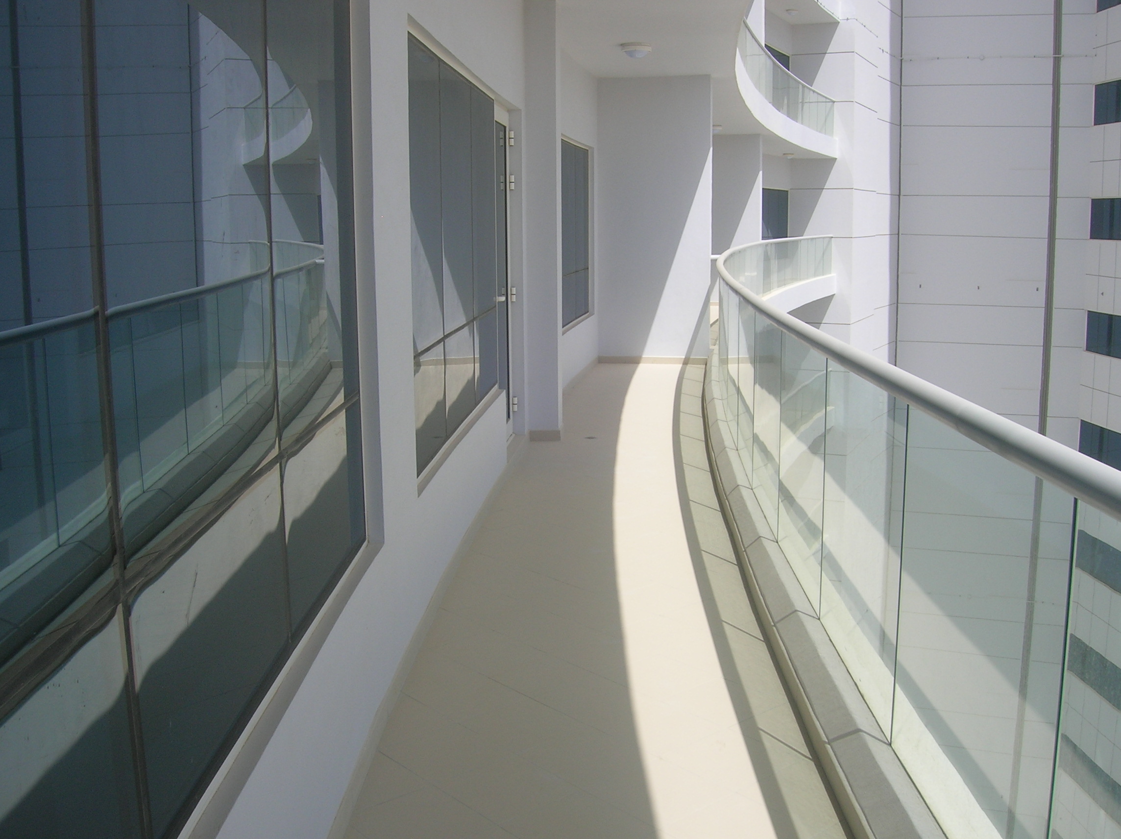 Oceanscape by Damac tower exterior at twilight on Al Reem Island, Abu Dhabi, illuminated against the city skyline