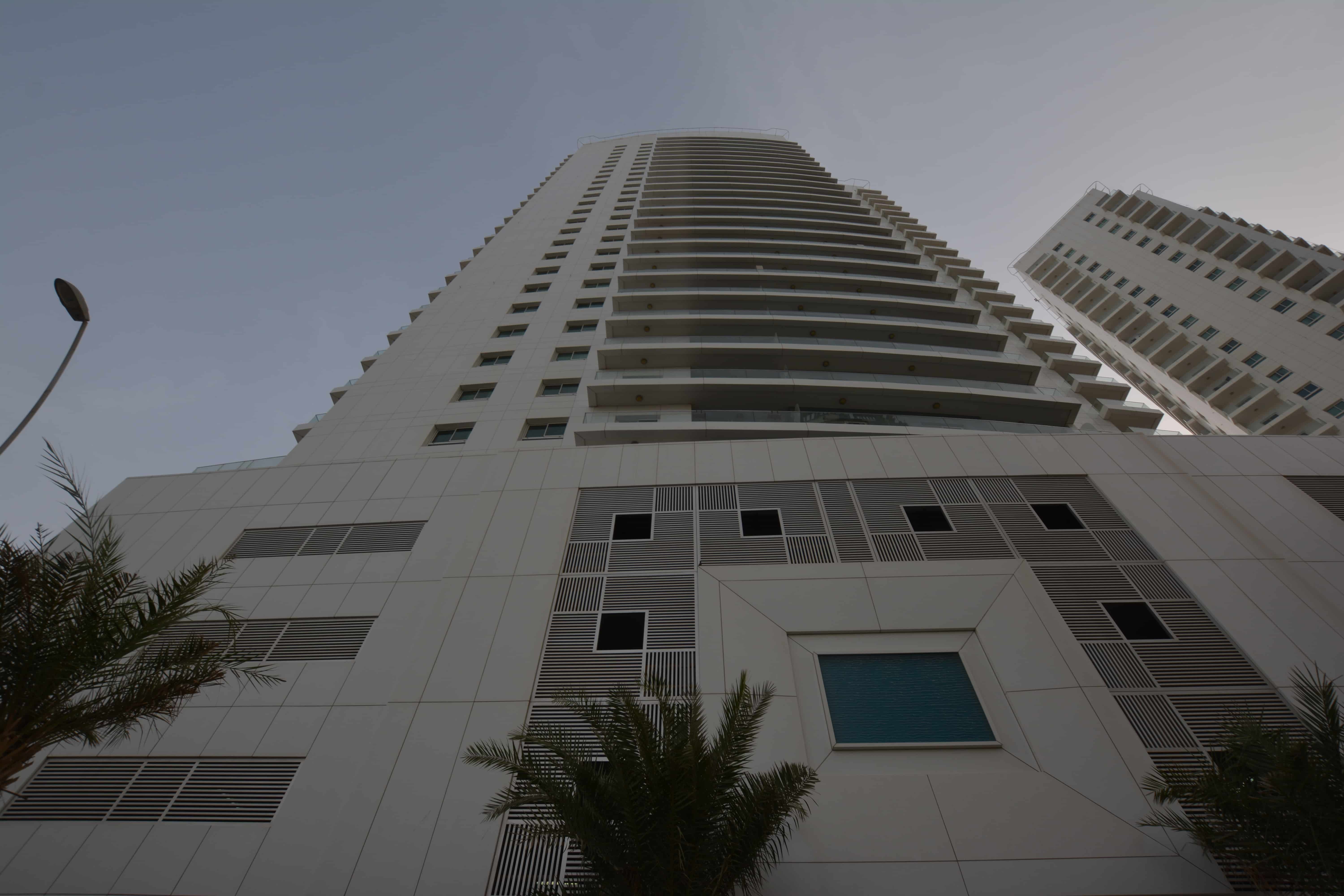 Modern residential exterior of Amaya Towers, Shams Abu Dhabi, Al Reem Island with landscaped podium and premium waterfront setting.