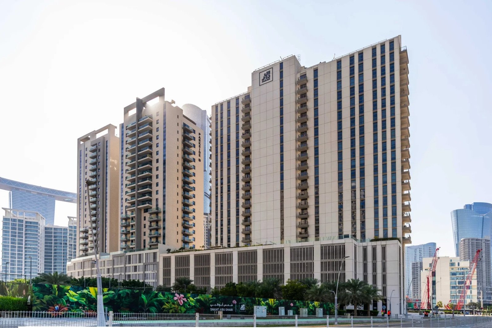 Sleek dual glass tower facade of Reflection Towers in City of Lights Al Reem Island Abu Dhabi waterfront development.